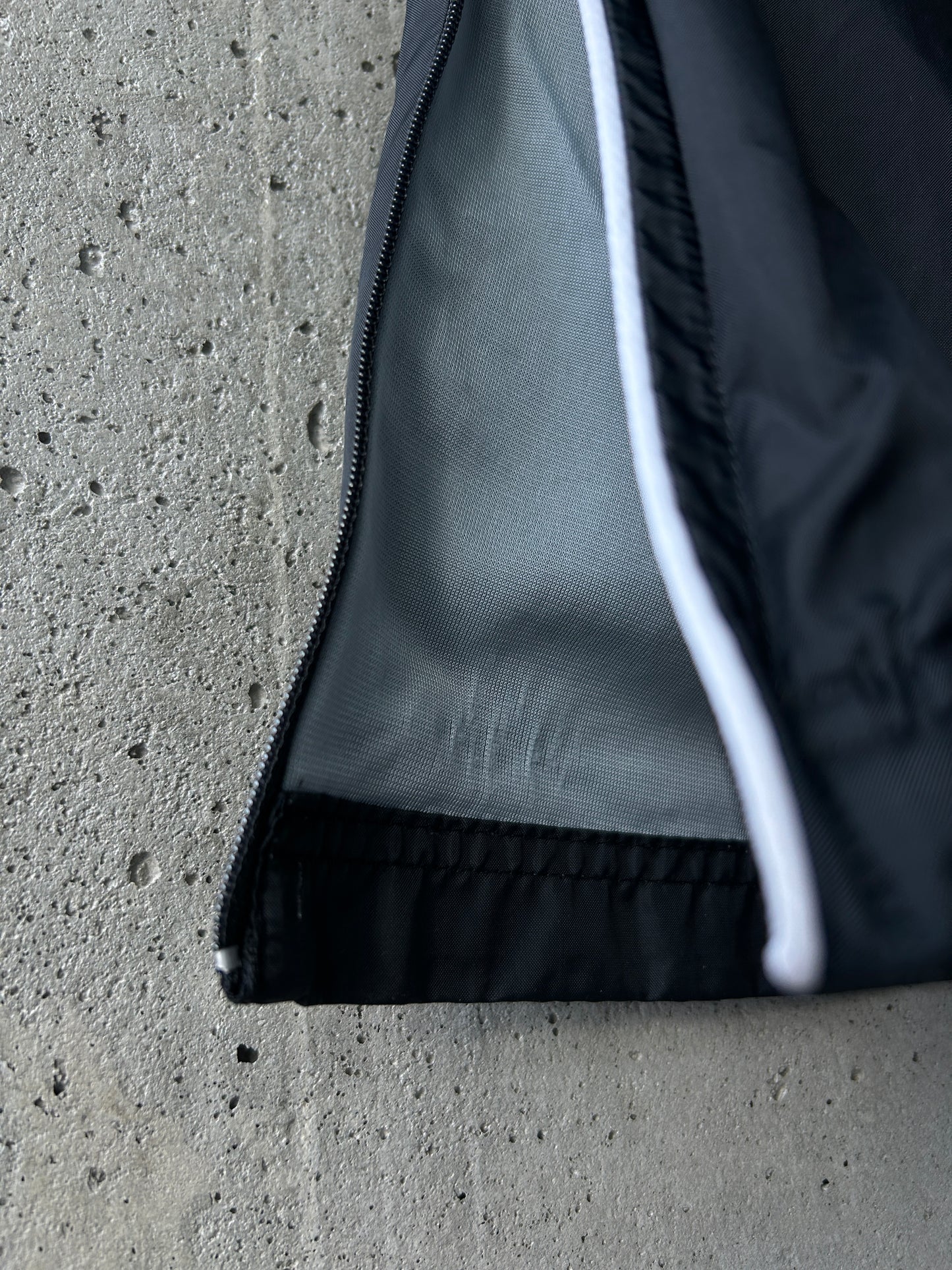 Nike black nylon ankle-zip track pants with white piping