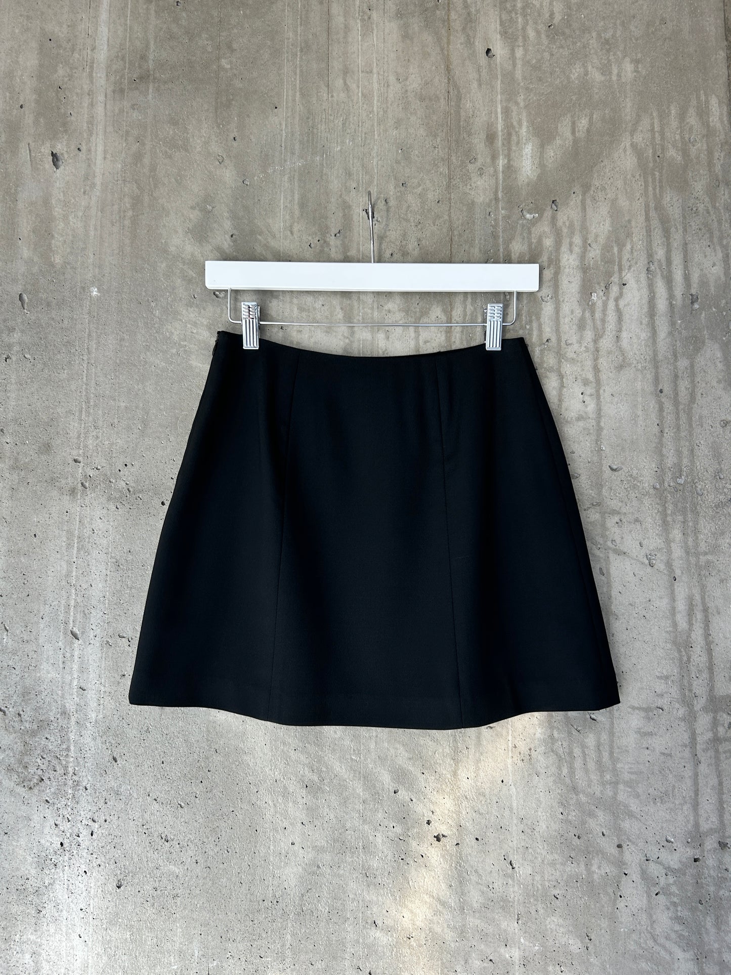 Holt Renfrew black wool mini skirt with slit hem