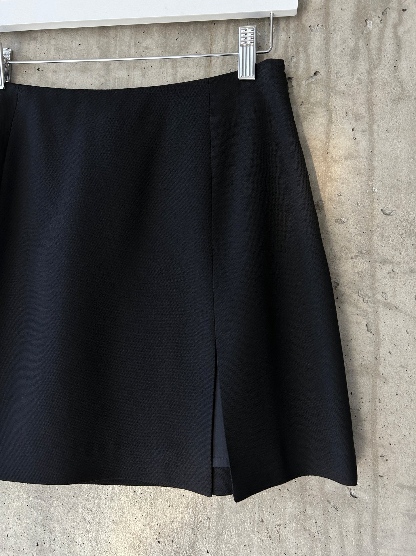 Holt Renfrew black wool mini skirt with slit hem