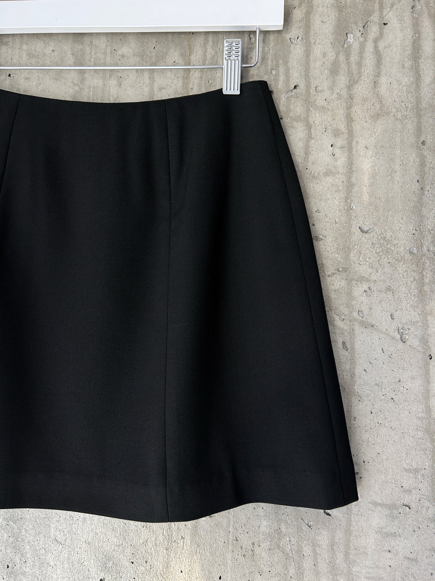 Holt Renfrew black wool mini skirt with slit hem